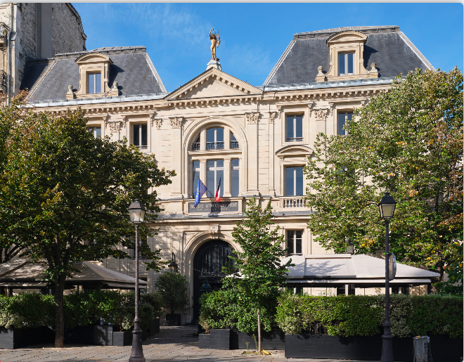 Façade du bâtiment historique de la Société d’Encouragement pour l’Industrie Nationale à Paris, architecture haussmannienne avec statue, drapeaux français et européen, siège emblématique de l’innovation et de l’industrie française.